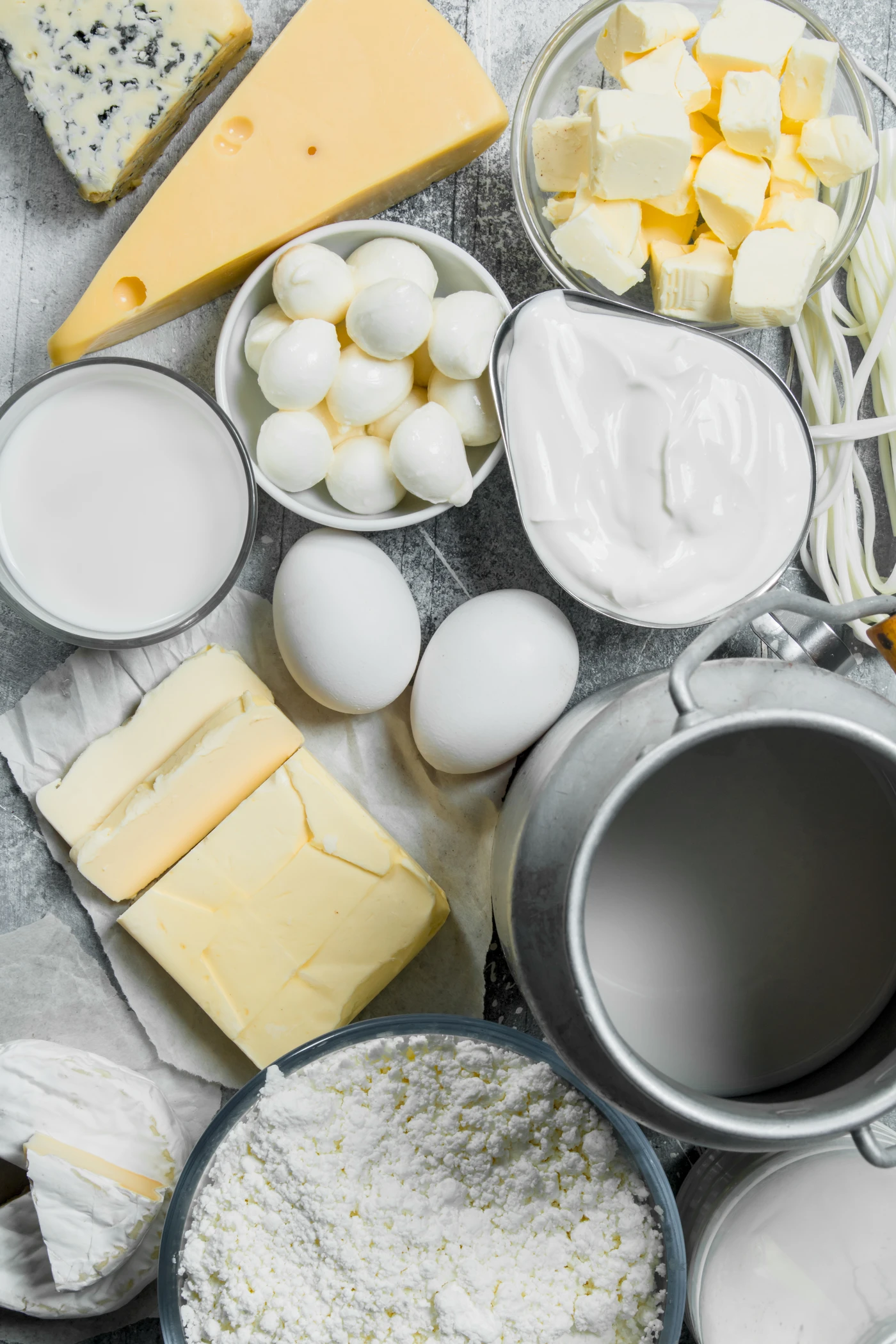 Productos lácteos y huevos frescos sobre fondo gris